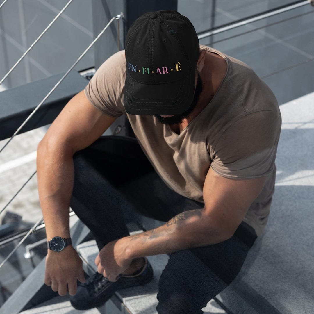 Distressed cotton dad hat with a pre-worn brim and the Enfiaré diamond emblem embroidered on the front.