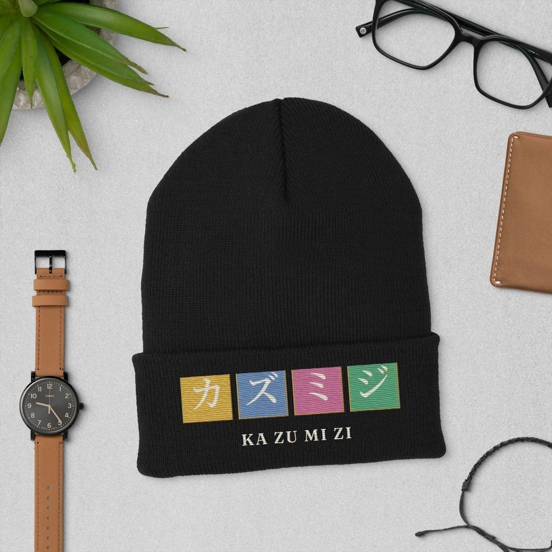 Cuffed knit beanie embroidered with the Kazumizi name in four stacked katakana characters.