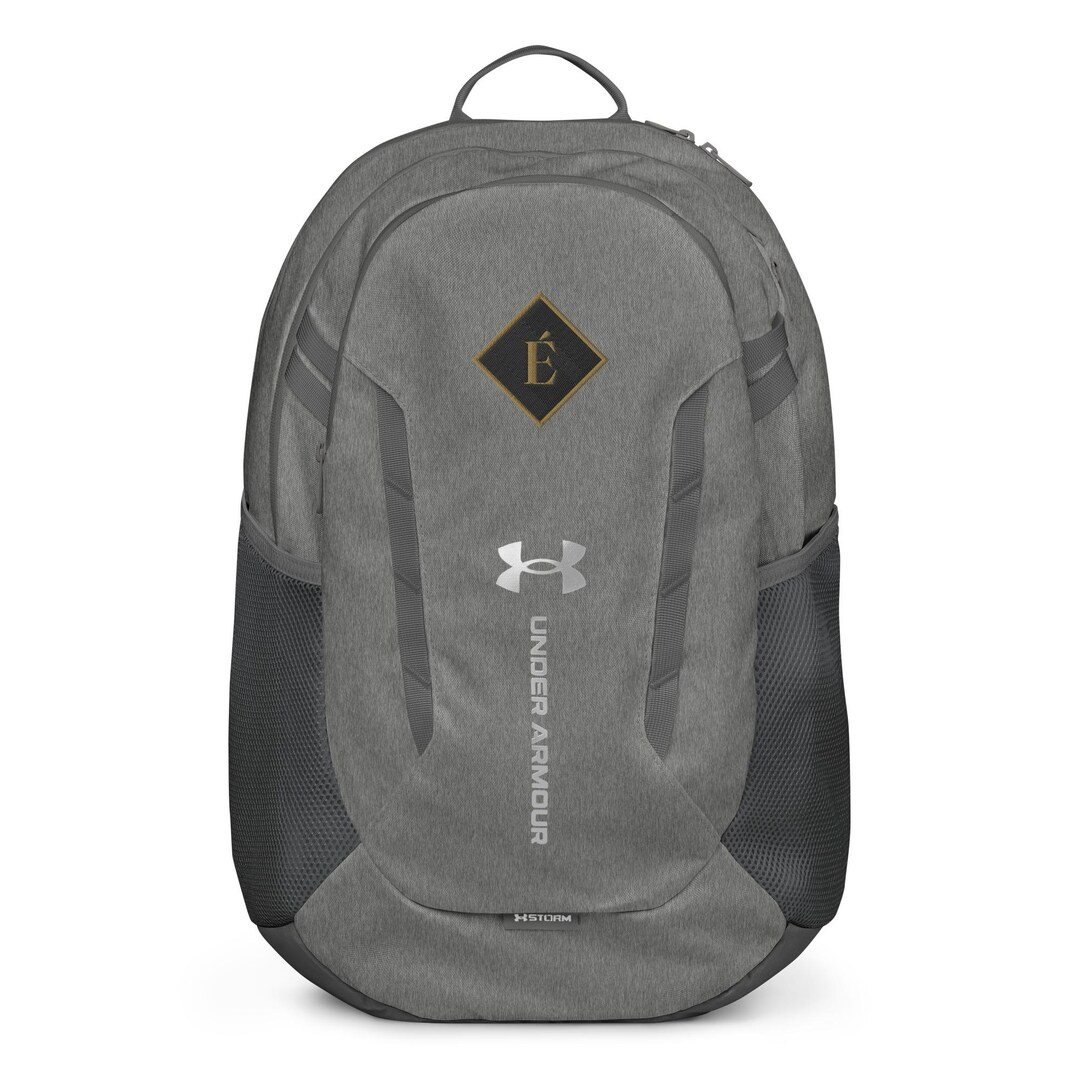 Under Armour Hustle 6.0 backpack in black with the Enfiaré mark in gold on the front panel.
